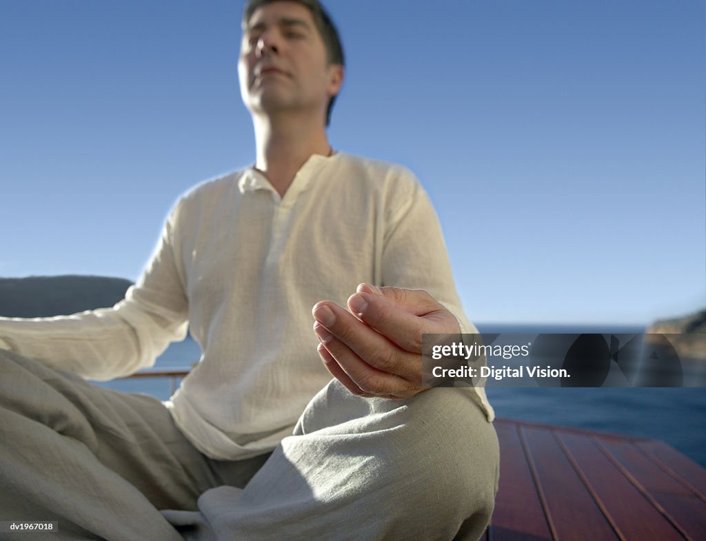 Serene Man Meditating Outdoors in the Lotus Position