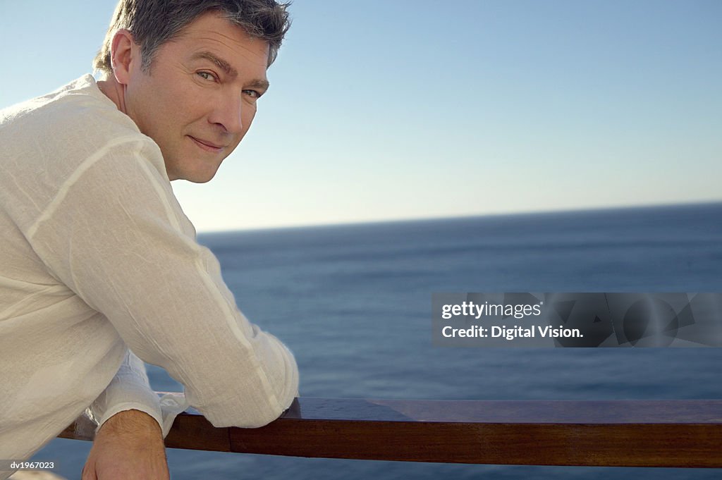 Portrait of a Man Leaning on a Railing by the Sea