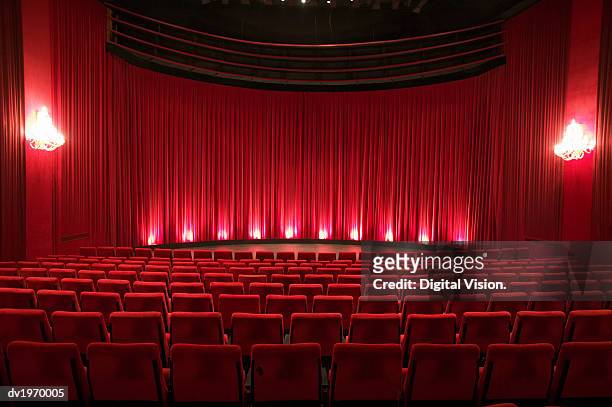 empty illuminated theatre - seat stock pictures, royalty-free photos & images