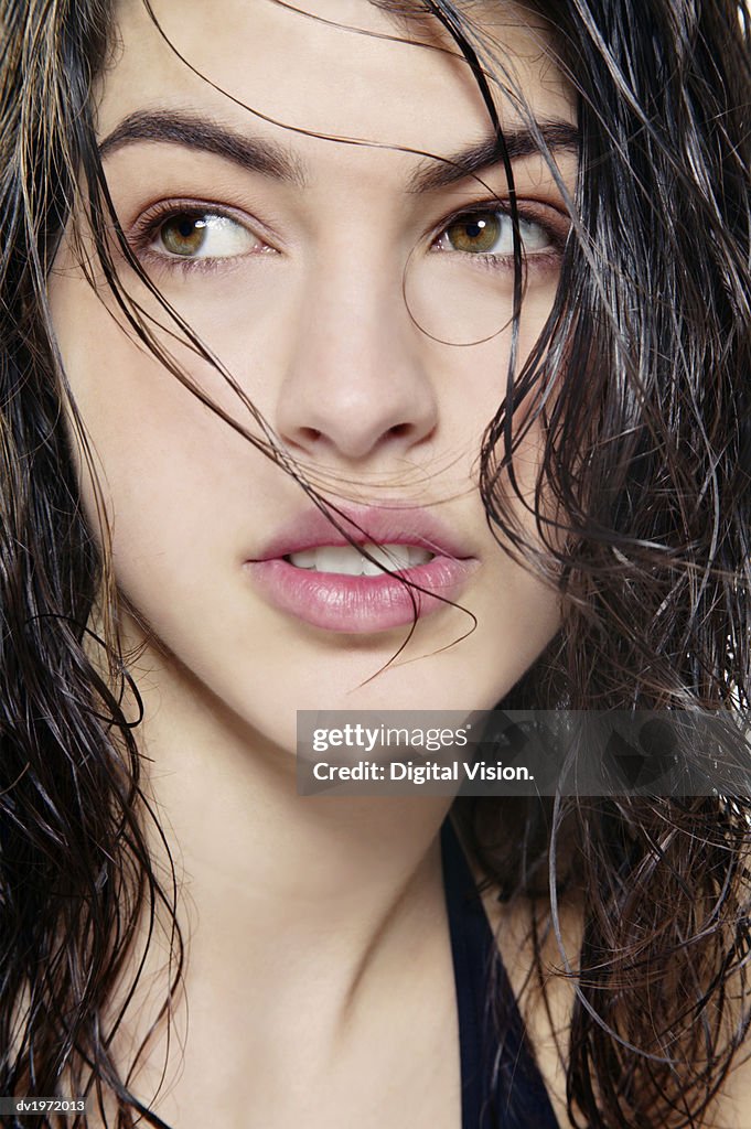 Studio Shot of a Young Woman with Wet and Tousled Hair