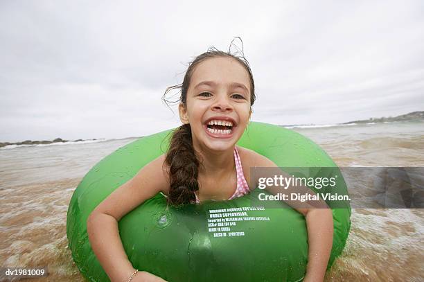 portrait of a young girl in a rubber ring, in the sea - rubber ring stock-fotos und bilder