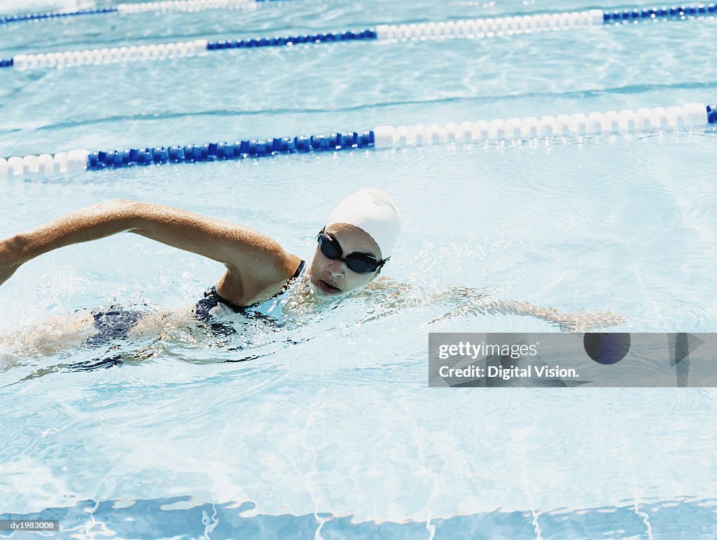 Young Woman Swimming in a Pool