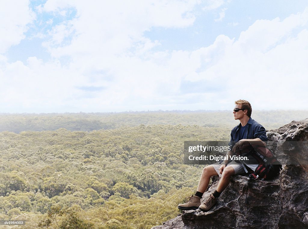 Man Sitting on a Mountain Summit Looking at View