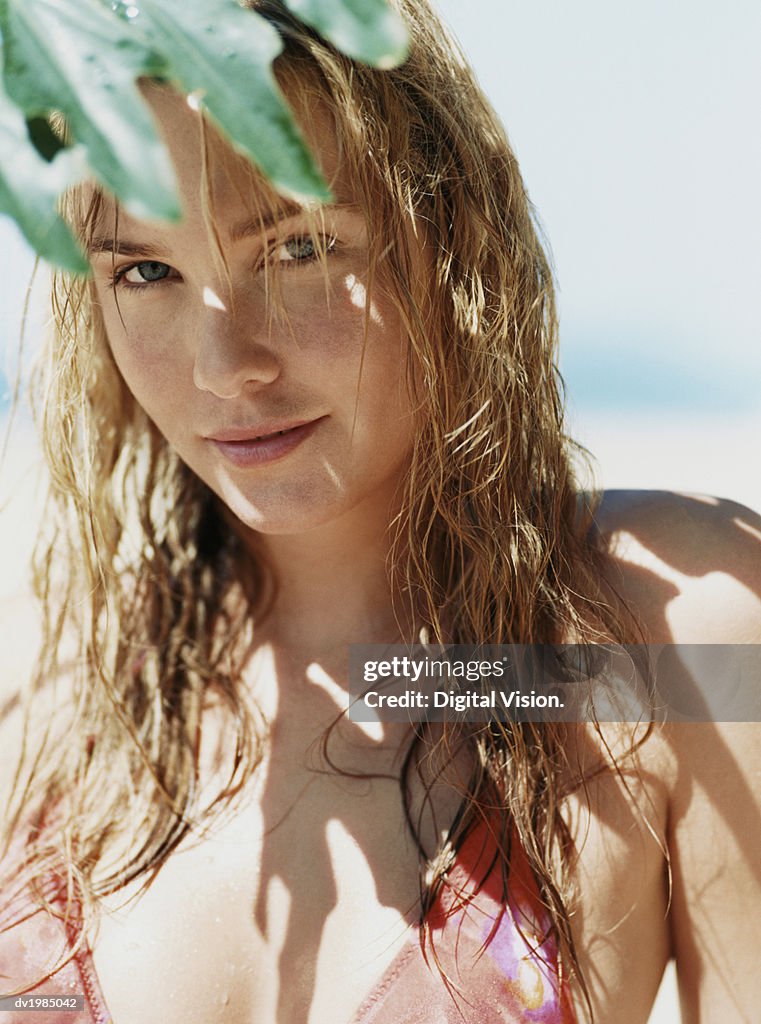 Woman Standing in The Shade of a Leaf