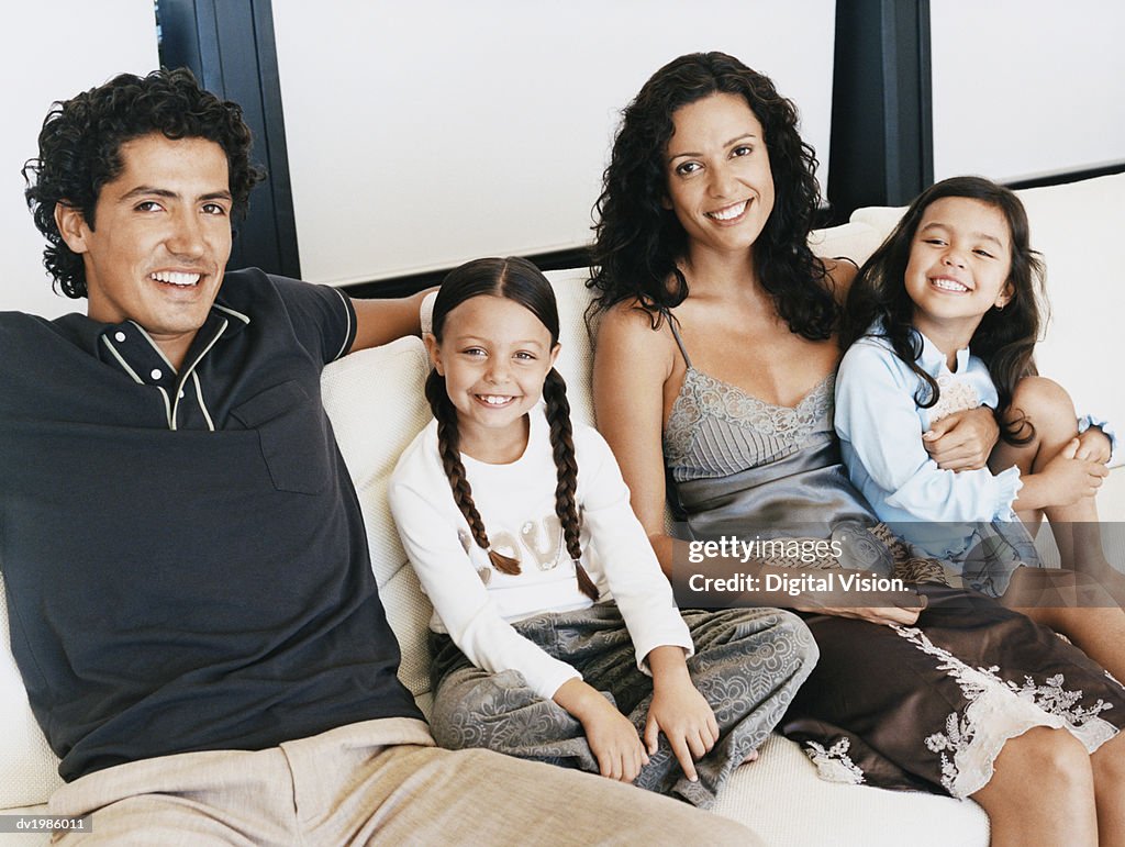 Portrait of a Family Sitting Together on a Sofa
