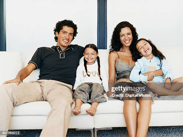 portrait of a family sitting together on a sofa - digital twin bildbanksfoton och bilder