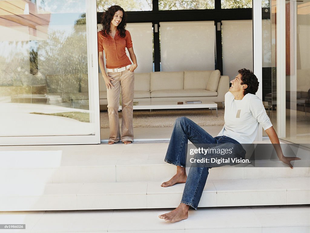 Couple Smiling at Each Other on the Patio of Their Home