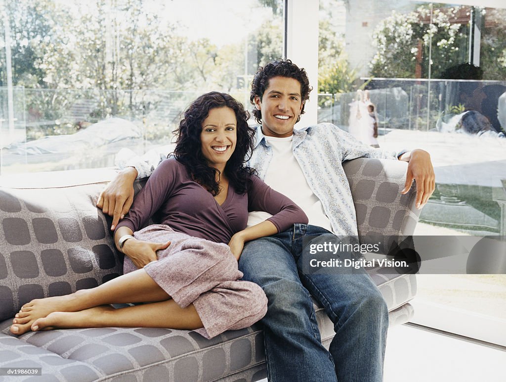 Portrait of a Couple Sitting on a Sofa in Their Home