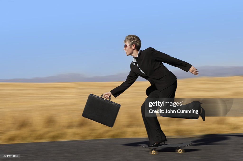 Businesswoman Riding on a Skateboard and Holding a Briefcase