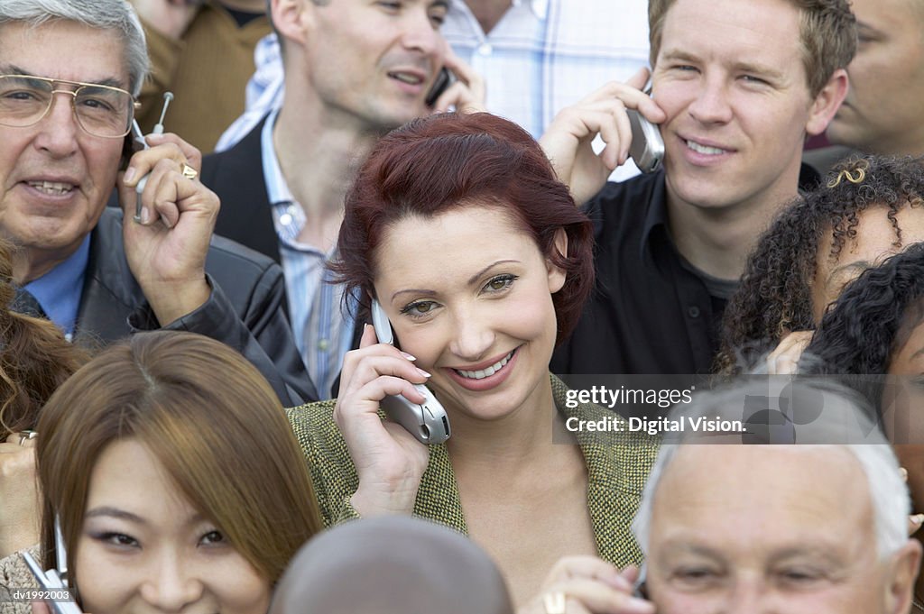 Focus on a Woman in a Large Crowd Using Mobile Phones