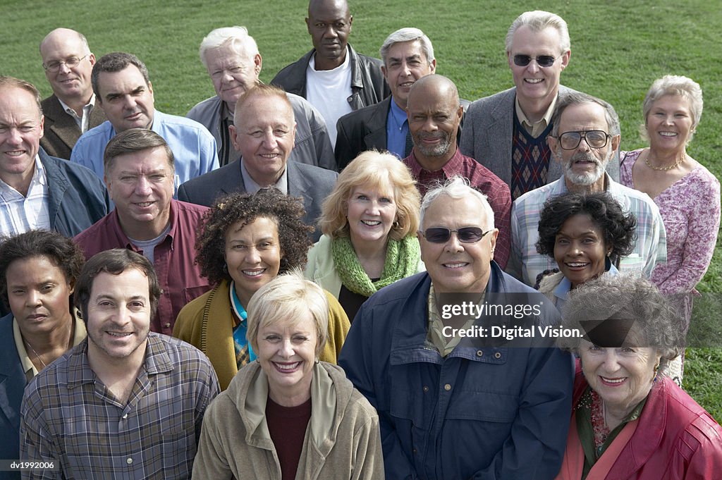 Large Crowd of People Standing Together on Grass