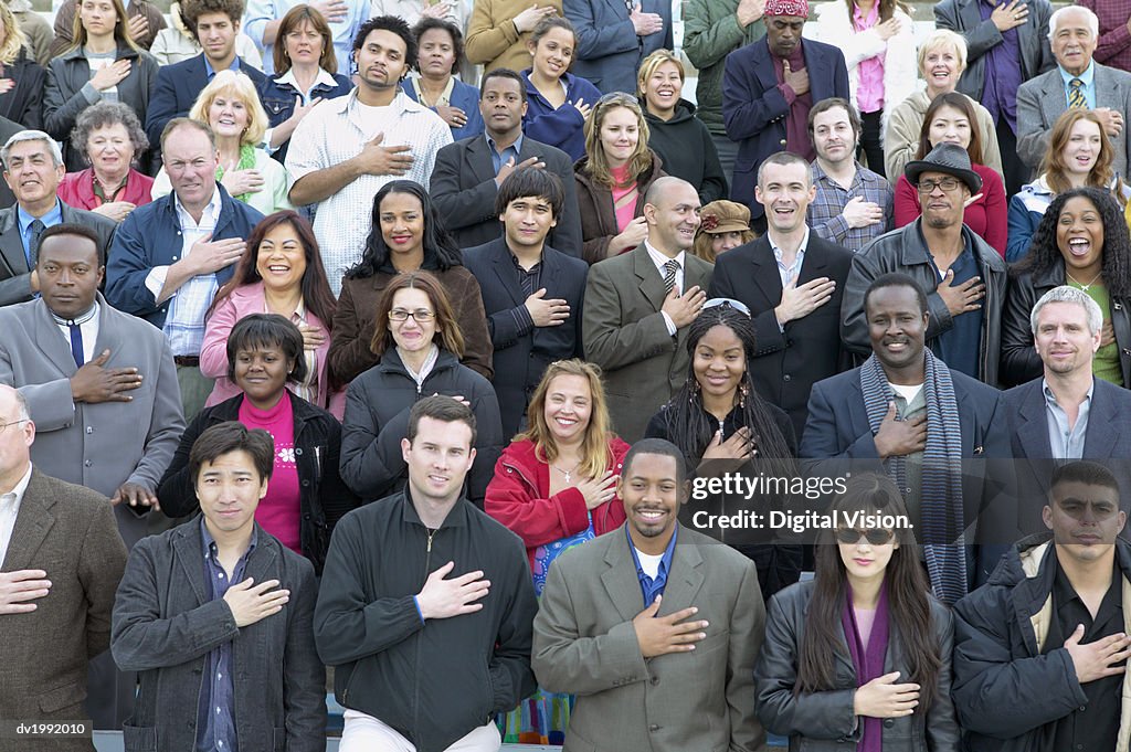 Large Crowd of People Standing in Rows and Pledging Allegiance