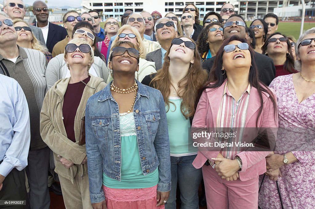 Crowd Standing Wearing Sunglasses Looking Up