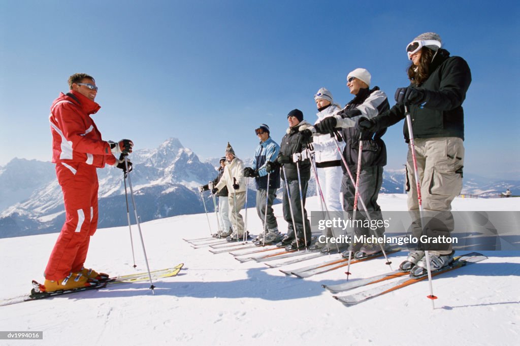 Ski Trainer With Men and Women on a Ski Slope