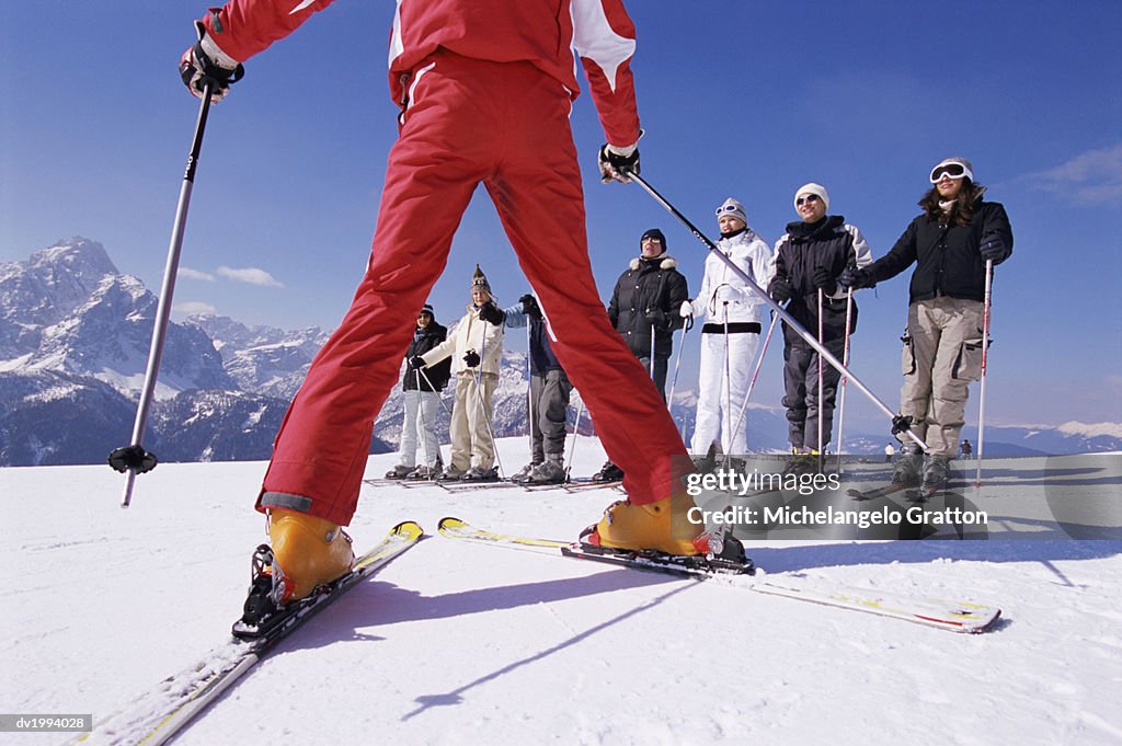 Ski Trainer Teaching Skiers on a Ski Slope