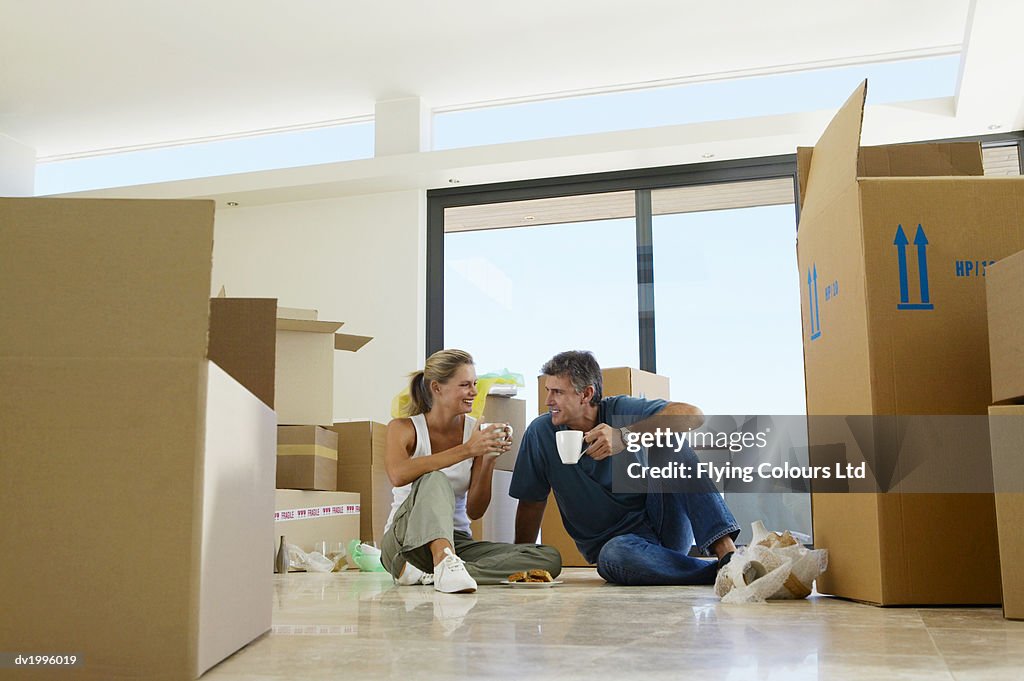 Mature Couple Moving into an Apartment, Taking a Coffee Break