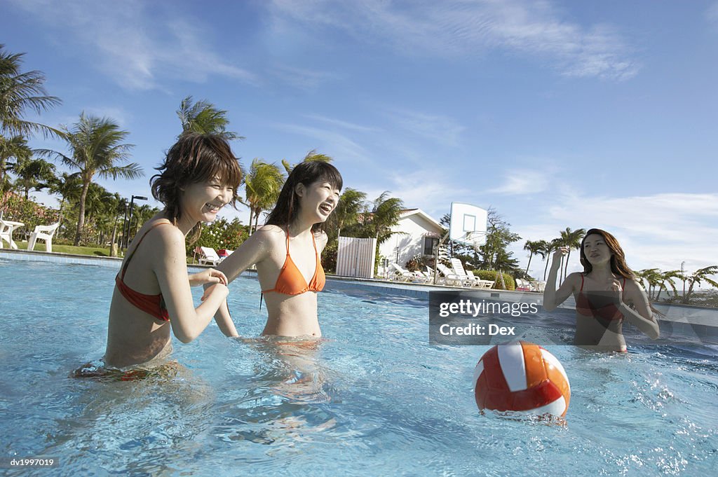 Three Friends Playing in a Swimming Pool