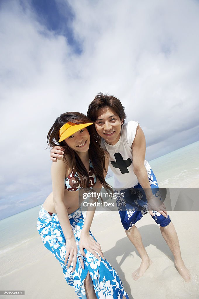 Portrait of a Young Couple in Swimwear Standing on the Beach