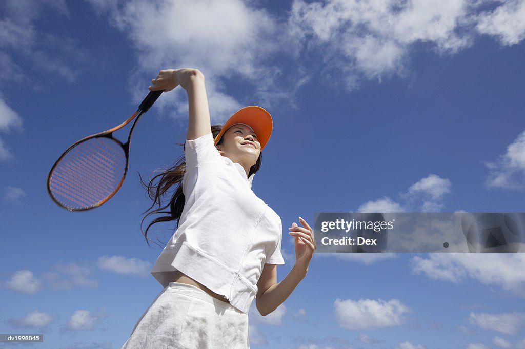 Low Angle View of a Young Woman Playing Tennis