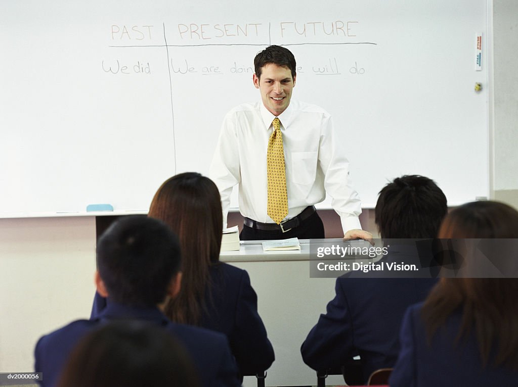 Teacher Talking to School Pupils in a Classroom