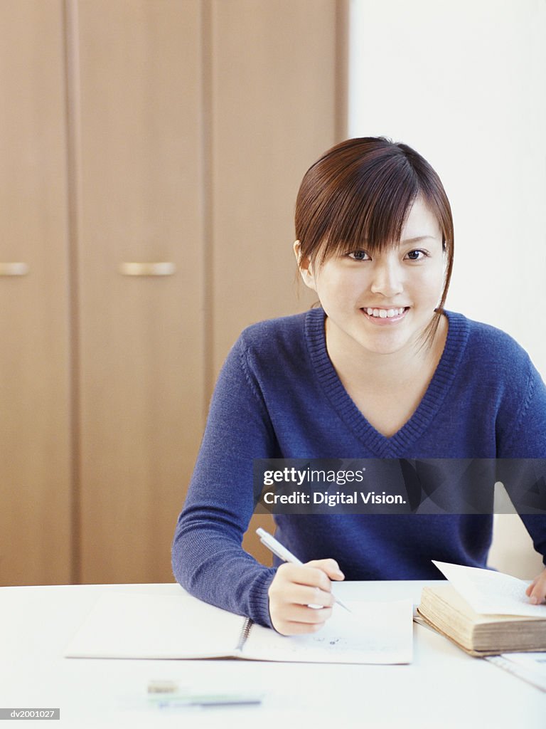 Portrait of a Schoolgirl Doing Her Homework at a Desk