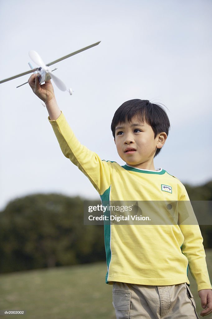 Boy Playing with a Model Plane