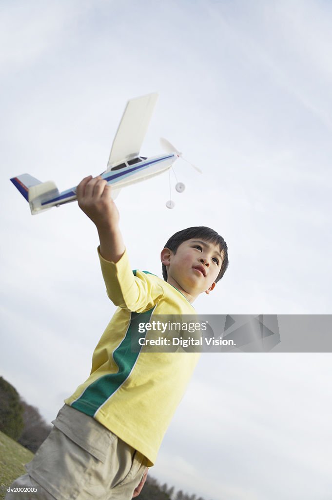Young Boy Playing with a Model Plane