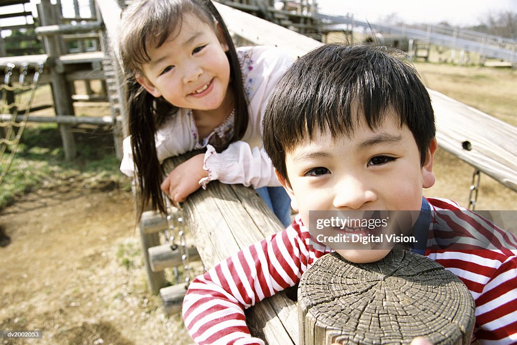 Close Up of a Young Boy and Girl Playing on an Adventure Playground