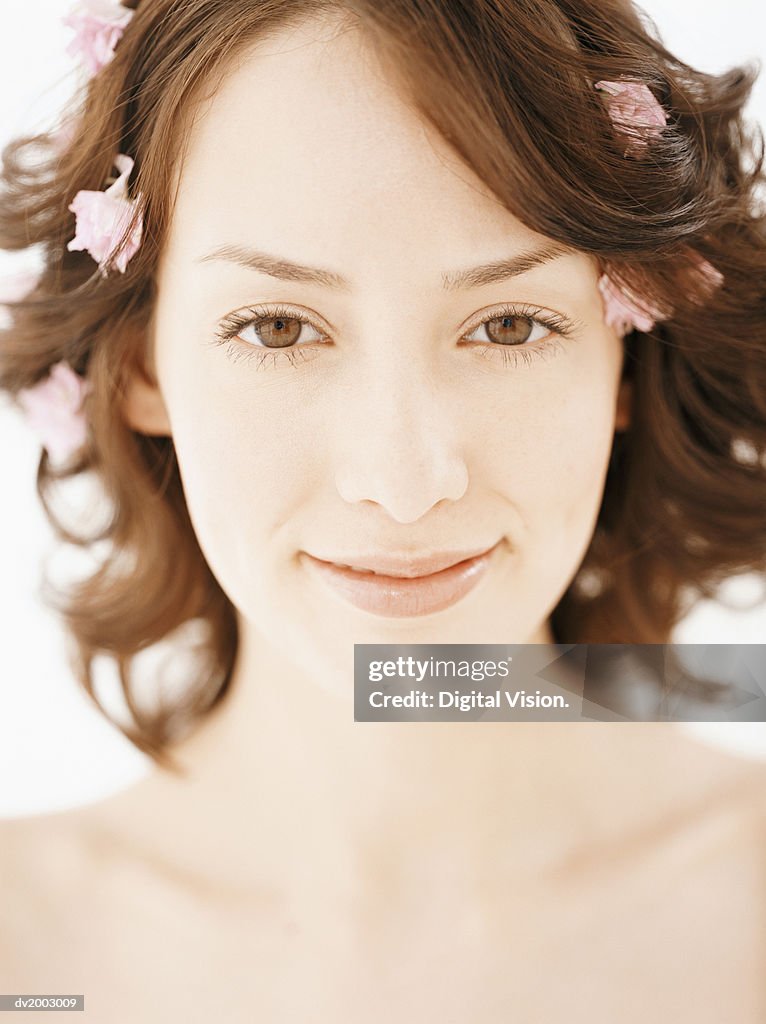 Studio Portrait of a Woman With Rose Petals in Her Hair