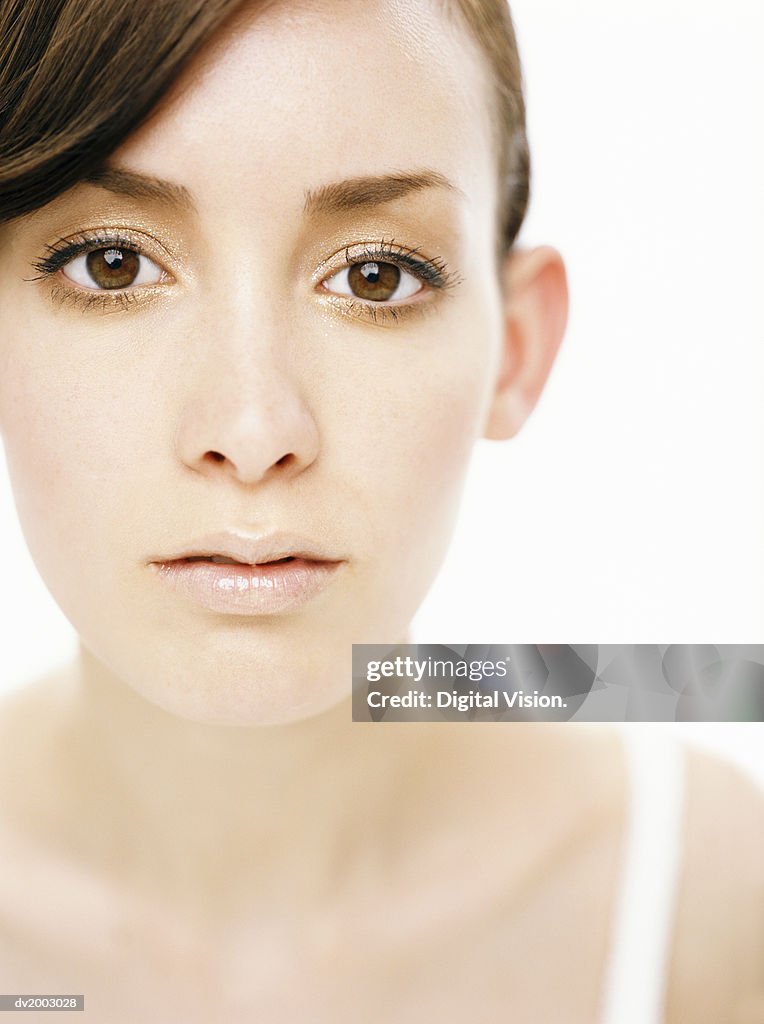 Studio Portrait of a Woman With Glitters Around Her Eyes