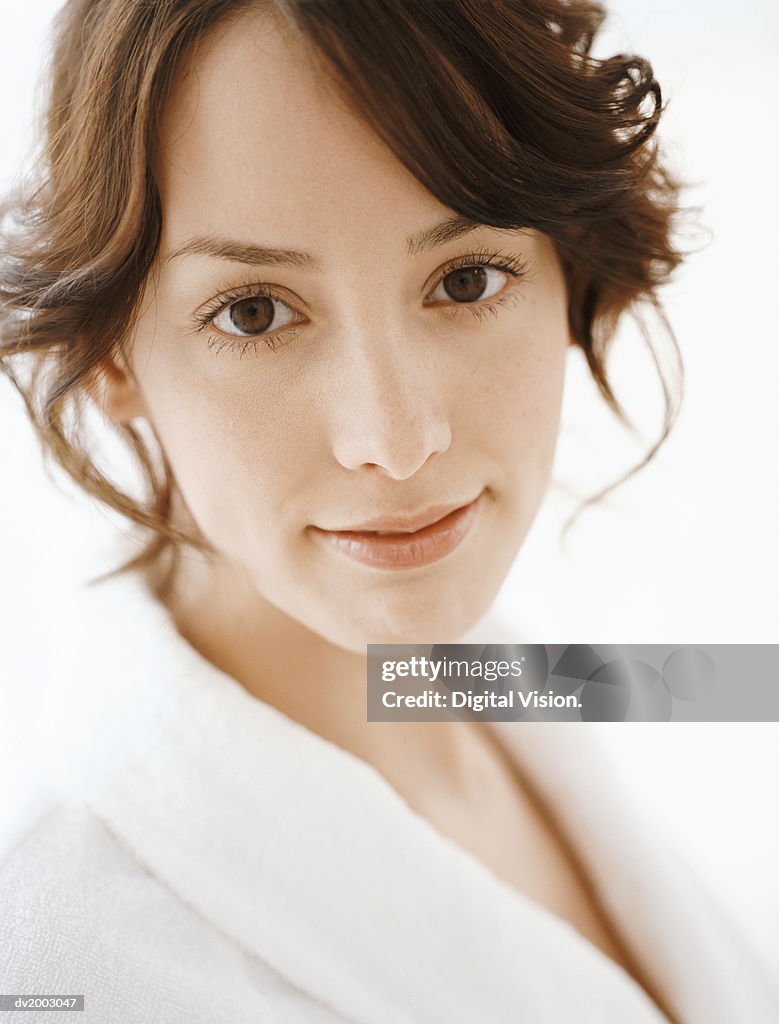 Studio Portrait of a Woman Wearing a White Bathrobe