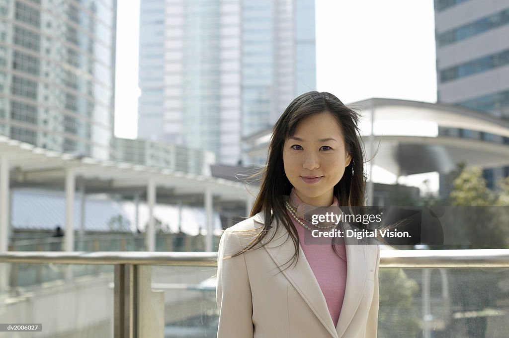 Portrait of a Businesswoman with Office Blocks in the Background