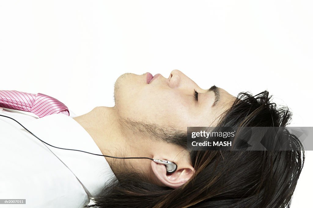 Profile of Man Lying and Listening to Headphones