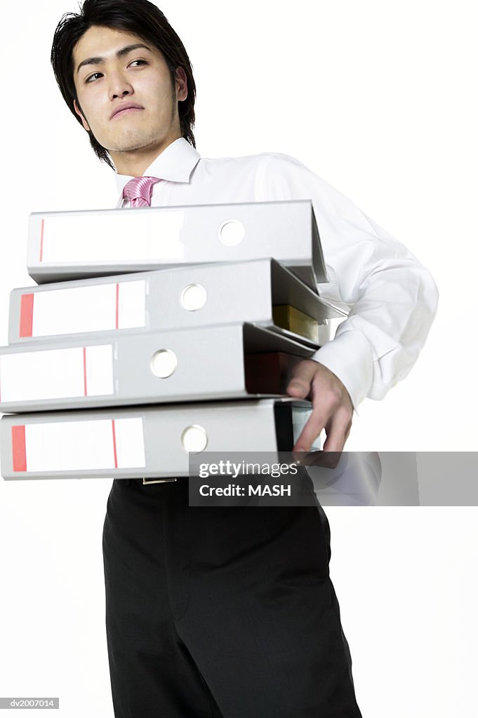 Businessman Carrying a Stack of Folders