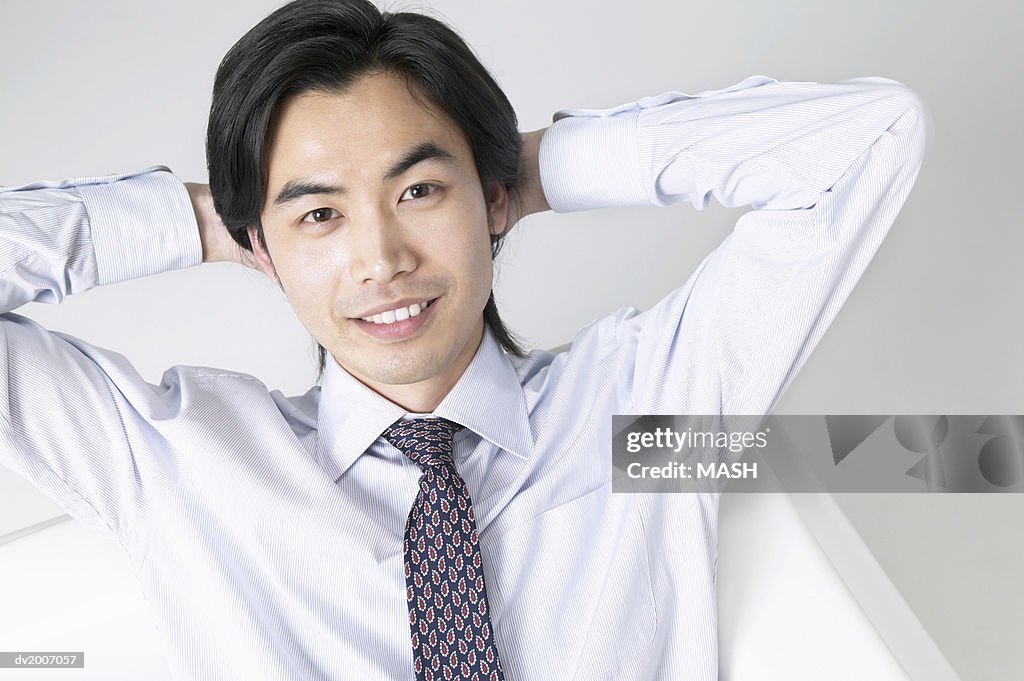 Portrait of a Businessman Sitting With His Hands Behind His Head