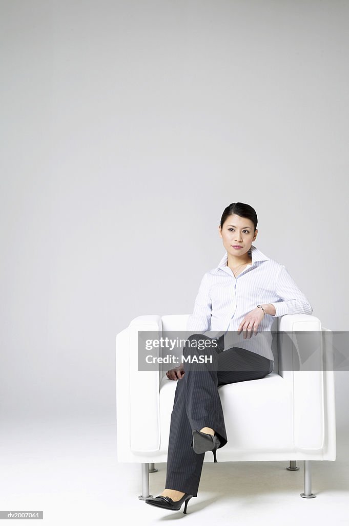 Businesswoman Sitting in an Armchair