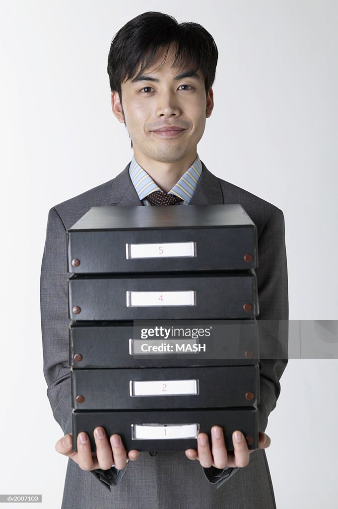 Businessman Carrying a Stack of Filing Boxes