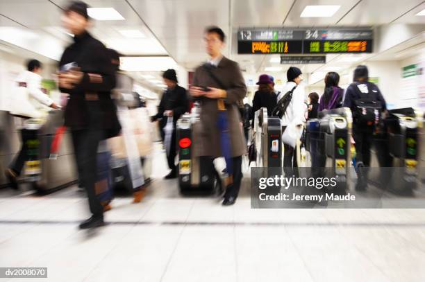 commuters walking through turnstiles, japan - barrier stock pictures, royalty-free photos & images