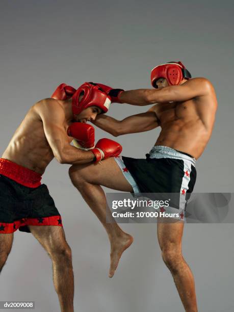two male kick boxers in a fight - head protector stock pictures, royalty-free photos & images