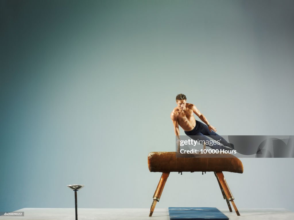 Male Athlete Using a Pommel Horse