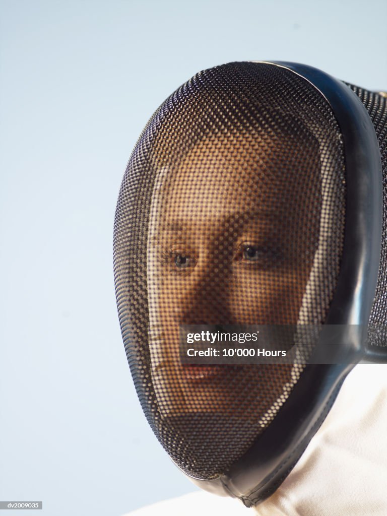 Portrait of a Female Fencer With a Mask Over Her Face