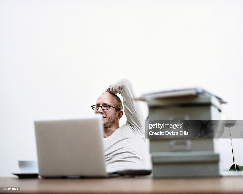 Man Working on a Laptop at Home