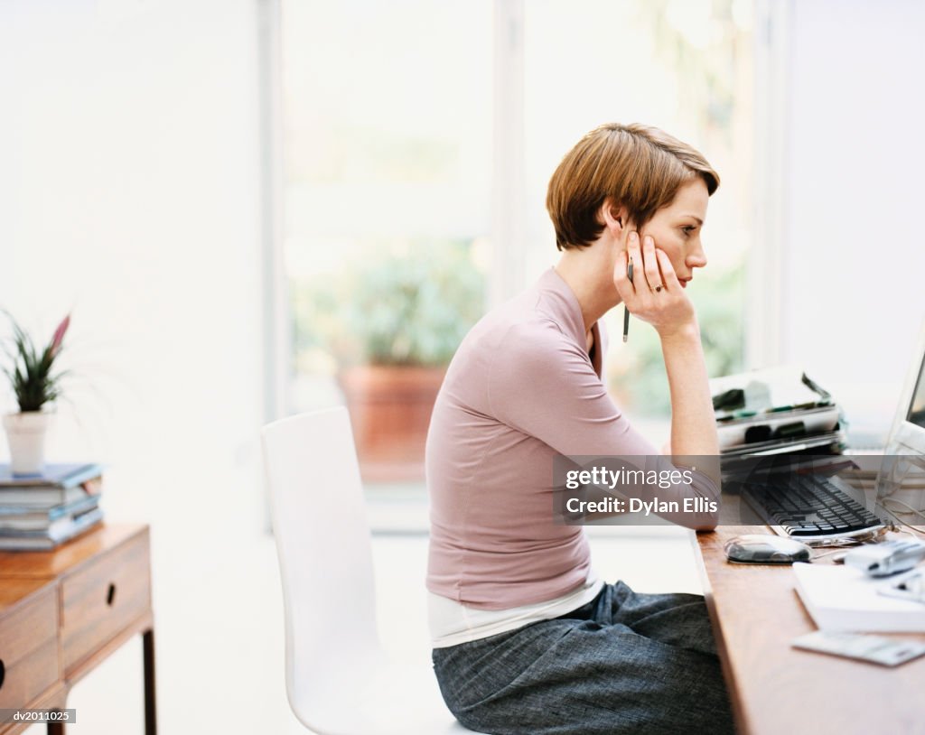 Woman Working on a Computer at Home