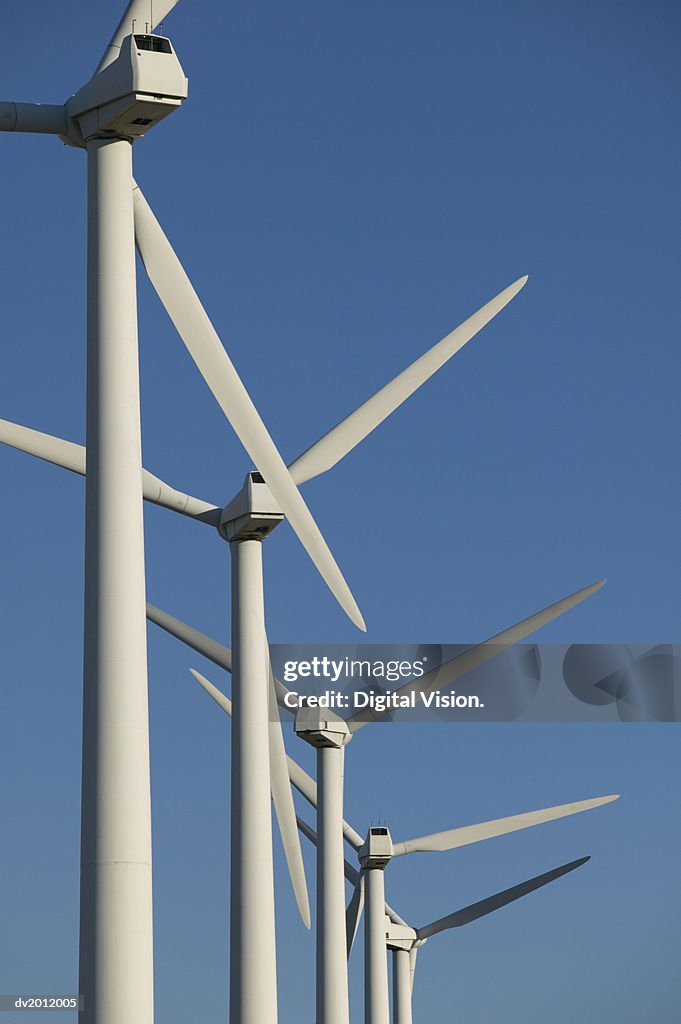 Five Wind Turbines Against a Blue Sky