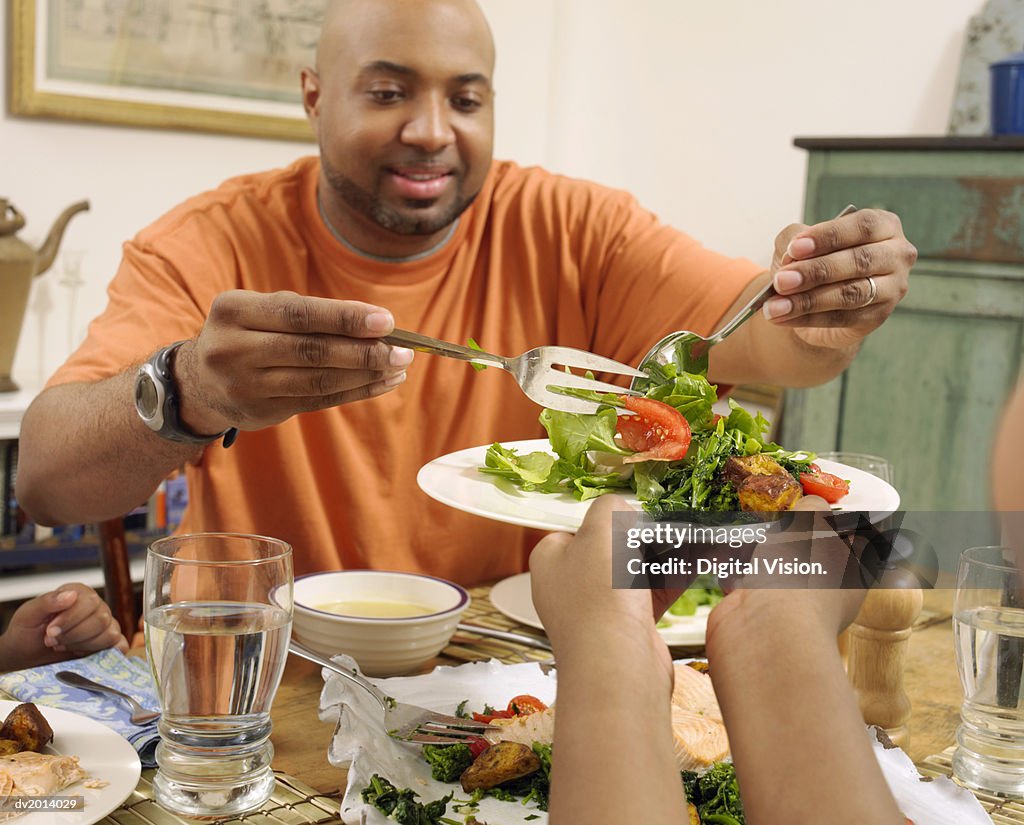 Father Serving Salad on a Plate