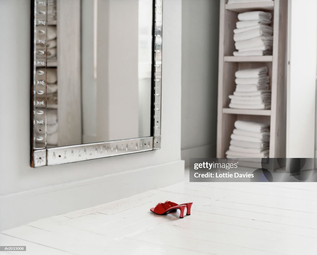 Red Mules in a White Bathroom