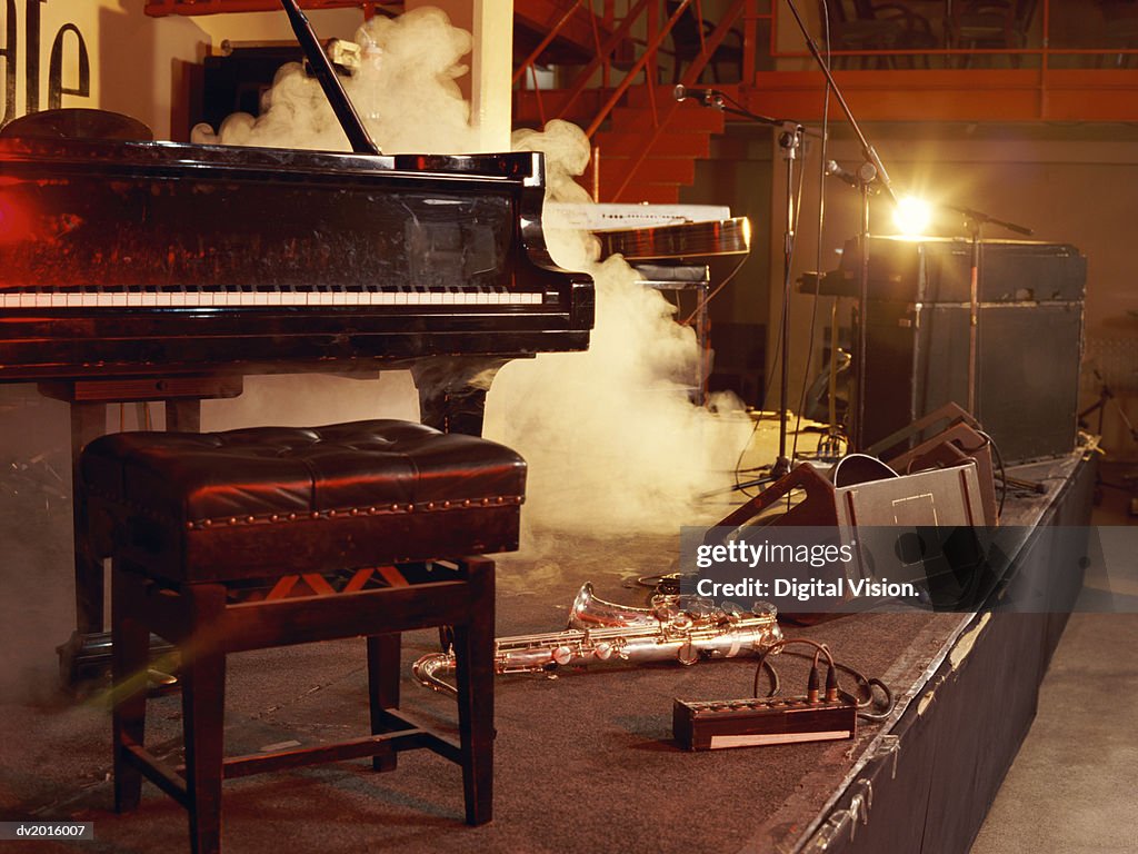 Piano, Saxophone and Microphone Stands on a Smoky Stage