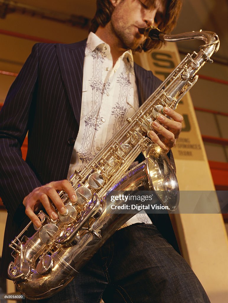 Low Angle Shot of a Man Playing a Saxophone