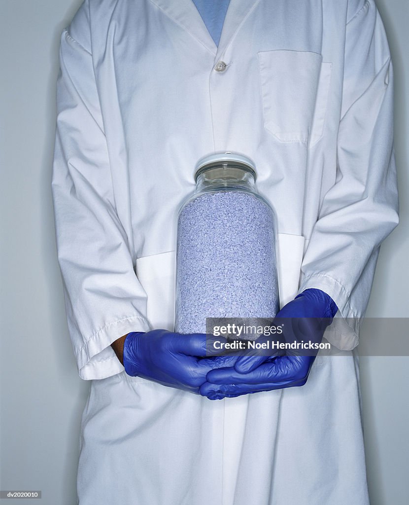 Mid Section Shot of a Lab Technician Holding a Jar