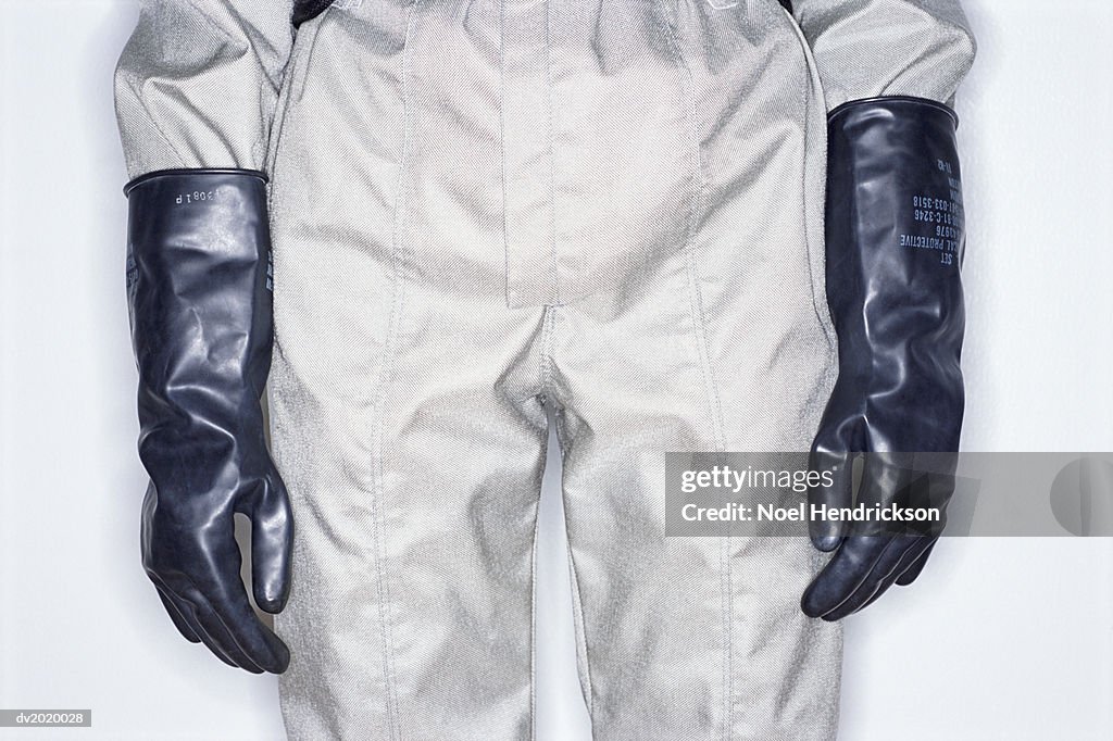 Mid Section Studio Shot of a Person Wearing a Protective Suit and Gloves